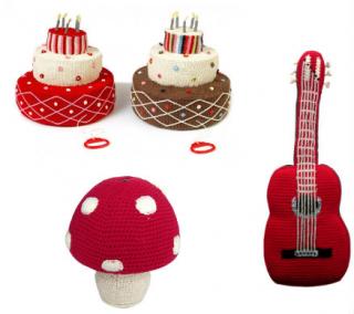 A birthday cake, a guitar and a mushroom shaped piggy bank.  