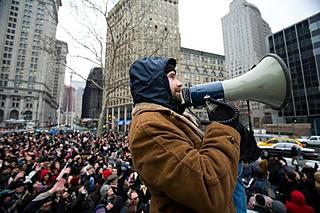 One of the organizers explains the “Mission” using a megaphone